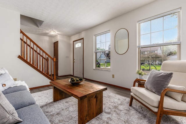 3351 Lindstrom Dr, Columbus, OH 43228 - living area featuring wood finished floors, stairway, and a textured ceiling