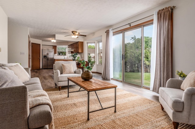 3351 Lindstrom Dr, Columbus, OH 43228 - living room with light wood-style floors, ceiling fan, and a textured ceiling
