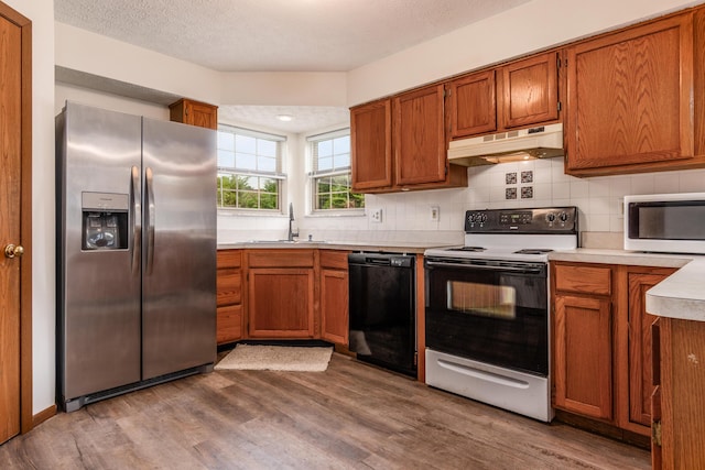 3351 Lindstrom Dr, Columbus, OH 43228 - kitchen featuring stainless steel refrigerator with ice dispenser, black dishwasher, electric range, under cabinet range hood, and white microwave