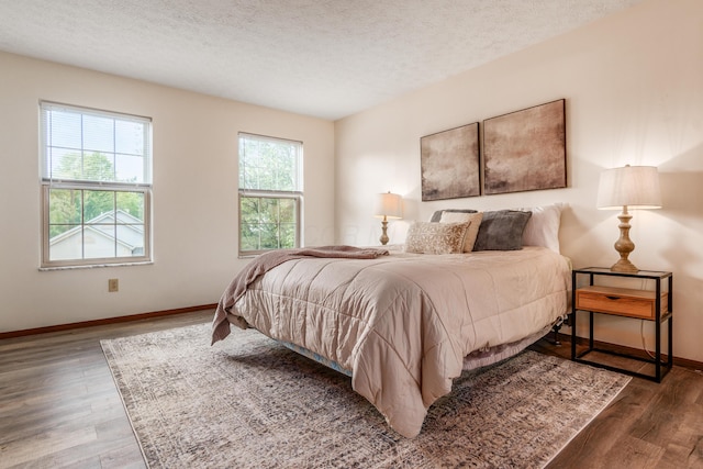 3351 Lindstrom Dr, Columbus, OH 43228 - bedroom with wood finished floors and a textured ceiling