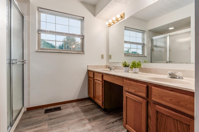 3351 Lindstrom Dr, Columbus, OH 43228 - full bath featuring double vanity, a stall shower, and wood finished floors