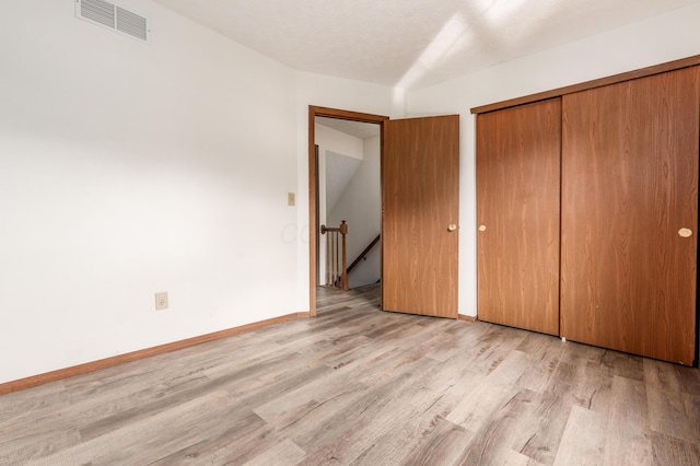 3351 Lindstrom Dr, Columbus, OH 43228 - unfurnished bedroom featuring light wood-style floors and a closet