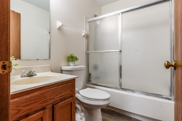3351 Lindstrom Dr, Columbus, OH 43228 - full bathroom featuring vanity, shower / bath combination with glass door, and wood finished floors