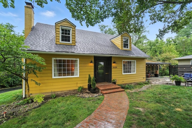 2620 Edgevale Rd, Columbus, OH 43221 - cape cod-style house with a front lawn, a chimney, roof with shingles, and a patio