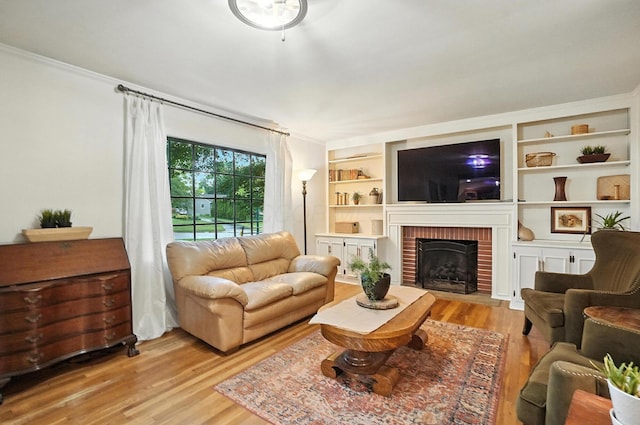 2620 Edgevale Rd, Columbus, OH 43221 - living area featuring wood finished floors, crown molding, and a brick fireplace