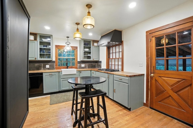 2620 Edgevale Rd, Columbus, OH 43221 - kitchen with black dishwasher, extractor fan, gas stovetop, backsplash, and light wood-type flooring