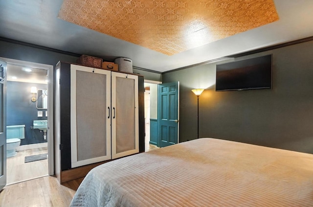 2620 Edgevale Rd, Columbus, OH 43221 - bedroom featuring wood finished floors, crown molding, and ensuite bath