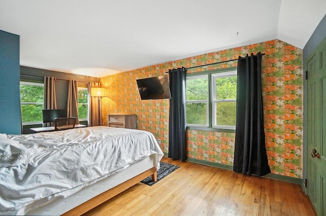 2620 Edgevale Rd, Columbus, OH 43221 - bedroom with wallpapered walls, wood finished floors, and lofted ceiling