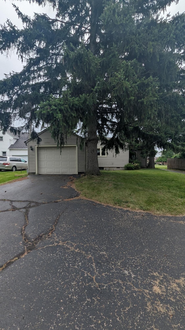 708 Fairview Ave, Galion, OH 44833 - view of home's exterior with a lawn, a garage, and asphalt driveway