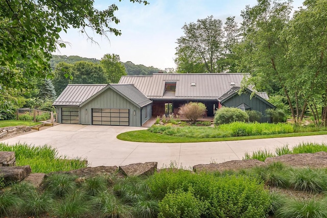 150 Pinehurst Dr, Granville, OH 43023 - view of front of home with a garage, a metal roof, driveway, and a standing seam roof