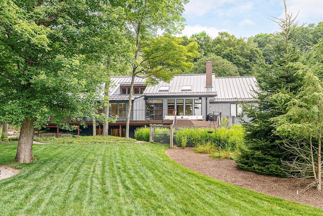 150 Pinehurst Dr, Granville, OH 43023 - back of property featuring a standing seam roof, a chimney, a lawn, and a wooden deck