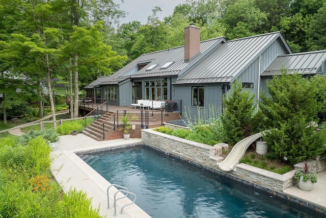 150 Pinehurst Dr, Granville, OH 43023 - rear view of property with a standing seam roof, a metal roof, a deck, a chimney, and an outdoor pool