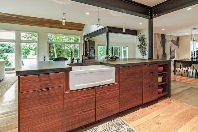 150 Pinehurst Dr, Granville, OH 43023 - kitchen with open floor plan, dark countertops, light wood-type flooring, recessed lighting, and modern cabinets