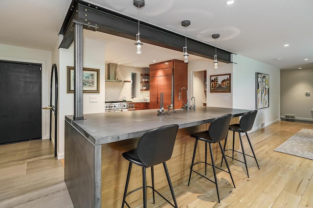 150 Pinehurst Dr, Granville, OH 43023 - kitchen featuring dark countertops, wall chimney exhaust hood, open shelves, light wood-type flooring, and recessed lighting