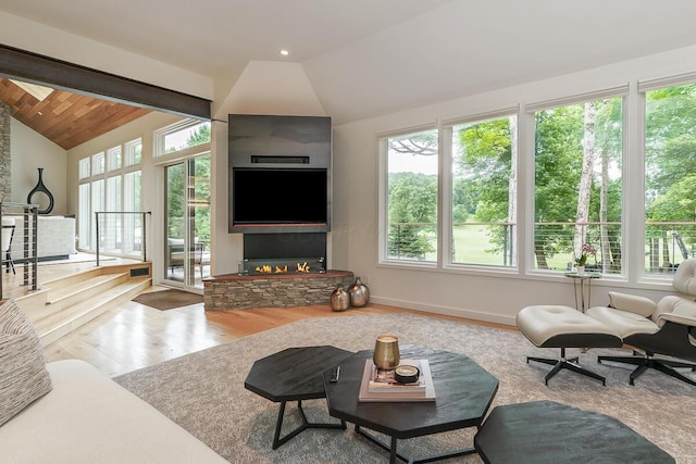 150 Pinehurst Dr, Granville, OH 43023 - living area with vaulted ceiling, healthy amount of natural light, wood finished floors, and a fireplace