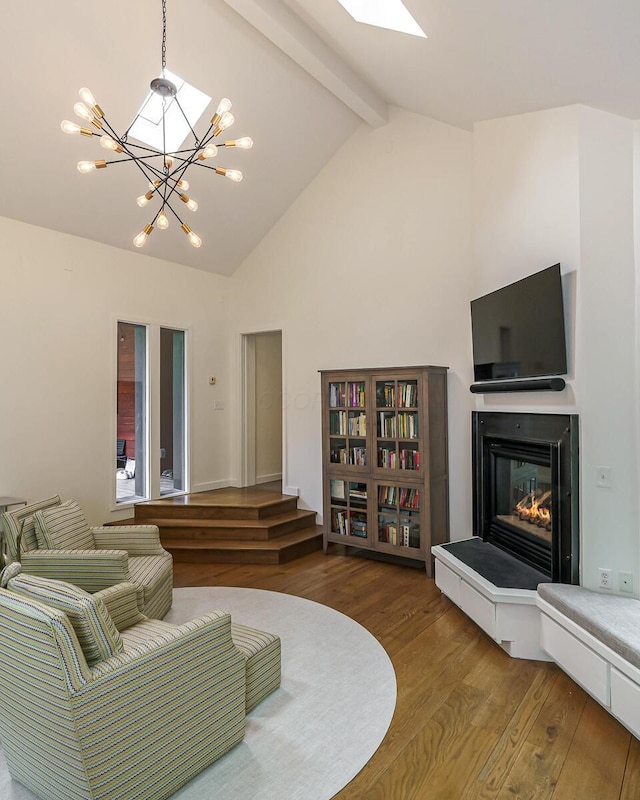 150 Pinehurst Dr, Granville, OH 43023 - living area featuring wood finished floors, a glass covered fireplace, a chandelier, beamed ceiling, and high vaulted ceiling