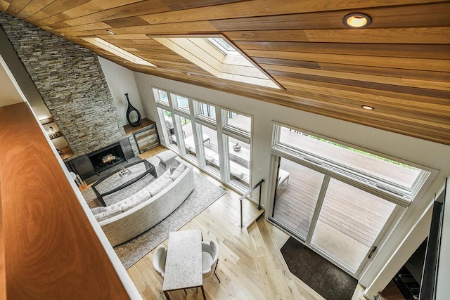 150 Pinehurst Dr, Granville, OH 43023 - living area with a skylight, wood ceiling, a fireplace, light wood-type flooring, and vaulted ceiling
