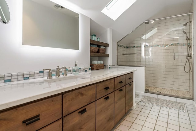 150 Pinehurst Dr, Granville, OH 43023 - bathroom with a skylight, vanity, a stall shower, tile patterned flooring, and vaulted ceiling
