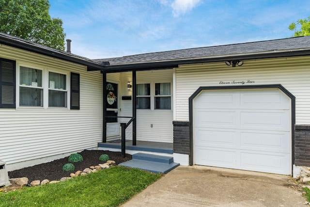 1174 Belden Rd, Columbus, OH 43229 - entrance to property with a garage, roof with shingles, driveway, and covered porch