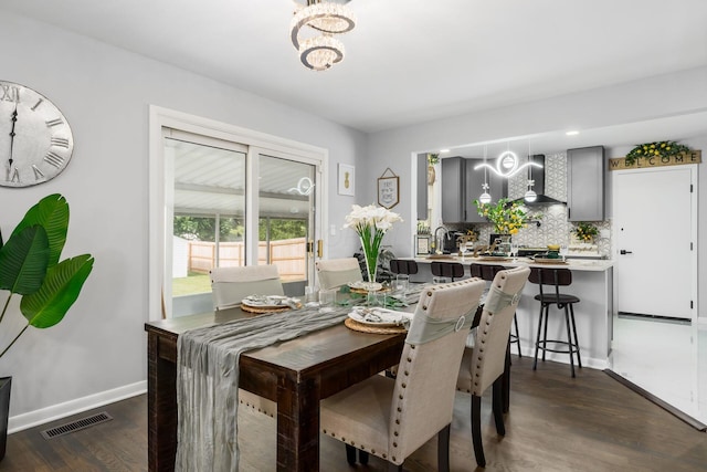 1174 Belden Rd, Columbus, OH 43229 - dining area with a chandelier and dark wood-style floors