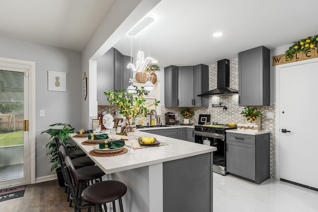 1174 Belden Rd, Columbus, OH 43229 - kitchen featuring range, wall chimney range hood, gray cabinets, light countertops, and recessed lighting