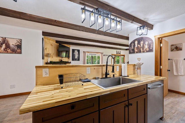 63775 State Route 56, Creola, OH 45622 - kitchen with butcher block counters, beam ceiling, dishwasher, light wood finished floors, and dark brown cabinetry