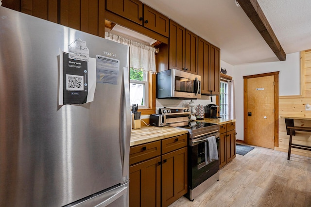 63775 State Route 56, Creola, OH 45622 - kitchen featuring stainless steel appliances, beam ceiling, light wood-type flooring, healthy amount of natural light, and wooden counters