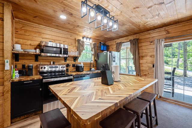 63775 State Route 56, Creola, OH 45622 - kitchen featuring stainless steel appliances, butcher block counters, dark cabinets, wood ceiling, and wood walls