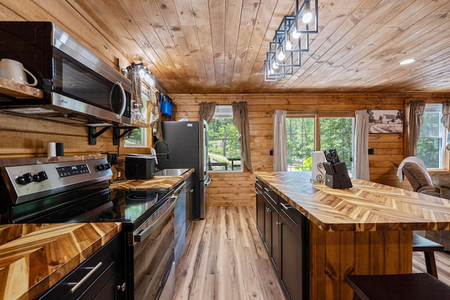 63775 State Route 56, Creola, OH 45622 - kitchen with butcher block countertops, appliances with stainless steel finishes, wooden ceiling, light wood-style floors, and plenty of natural light