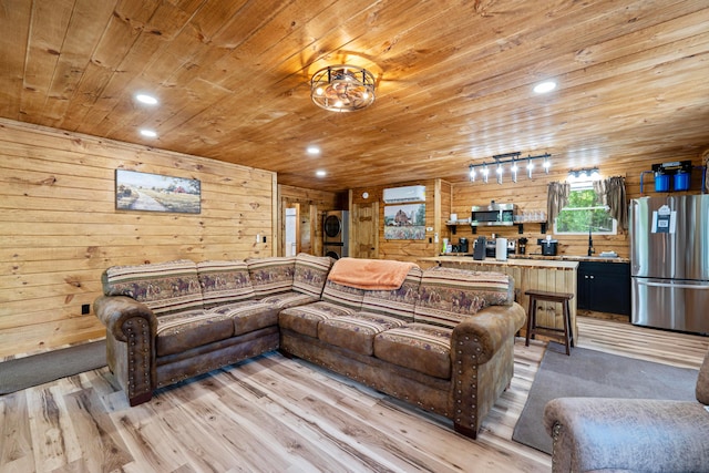 63775 State Route 56, Creola, OH 45622 - living area featuring wood ceiling, wood walls, light wood finished floors, stacked washer / drying machine, and recessed lighting