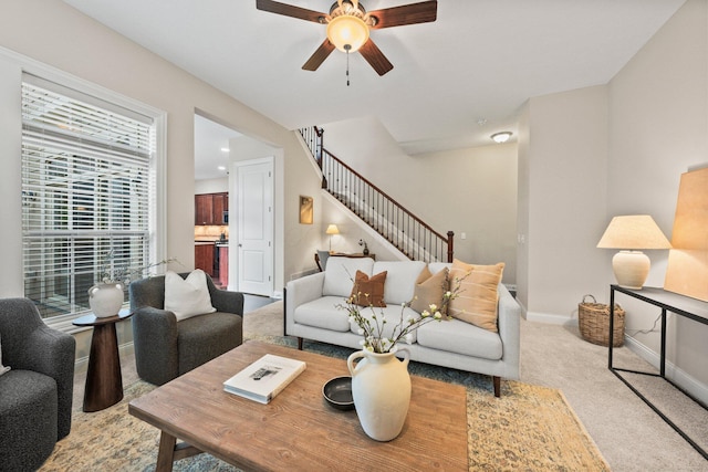 4190 Troutbrook Dr Unit 128, Dublin, OH 43017 - living room featuring carpet flooring, ceiling fan, and stairs
