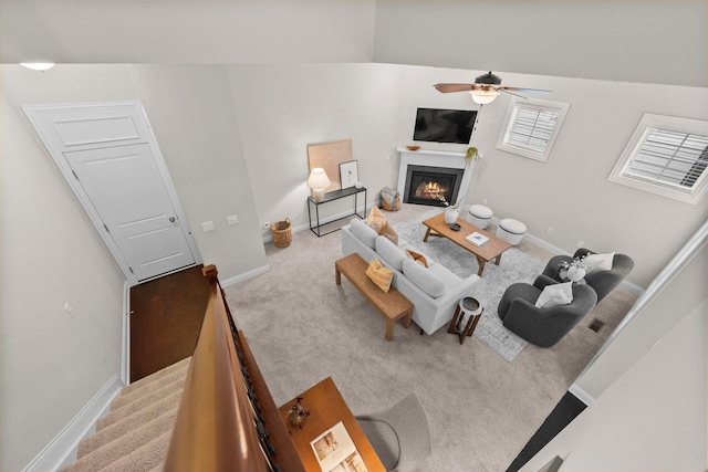 4190 Troutbrook Dr Unit 128, Dublin, OH 43017 - living room featuring light colored carpet, ceiling fan, and a glass covered fireplace
