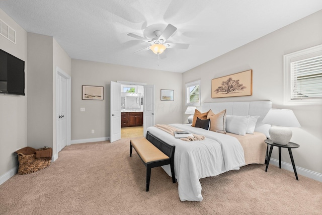 4190 Troutbrook Dr Unit 128, Dublin, OH 43017 - bedroom featuring light carpet, ensuite bathroom, and ceiling fan