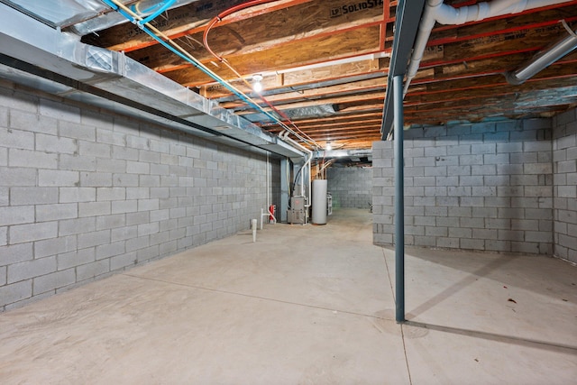 4190 Troutbrook Dr Unit 128, Dublin, OH 43017 - unfinished below grade area with gas water heater, heating unit, and concrete block wall