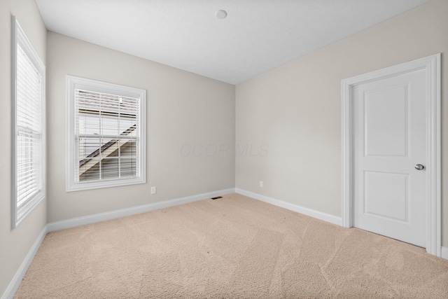 4190 Troutbrook Dr Unit 128, Dublin, OH 43017 - empty room featuring light carpet and plenty of natural light