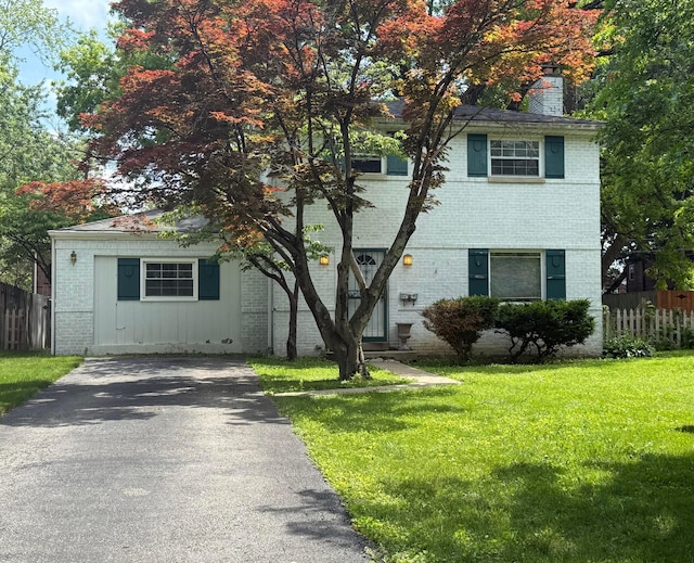 2909 Bryden Rd, Columbus, OH 43209 - view of front of home with brick siding, a chimney, and driveway