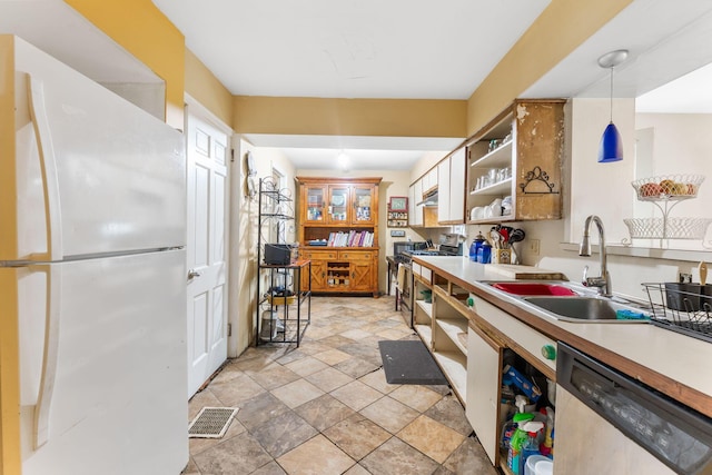 2909 Bryden Rd, Columbus, OH 43209 - kitchen with freestanding refrigerator, stainless steel dishwasher, open shelves, light stone finish floors, and light countertops
