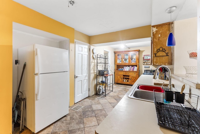 2909 Bryden Rd, Columbus, OH 43209 - kitchen with freestanding refrigerator, decorative light fixtures, and light countertops