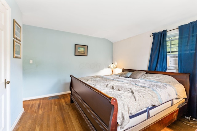 2909 Bryden Rd, Columbus, OH 43209 - bedroom with wood finished floors, cooling unit, and lofted ceiling