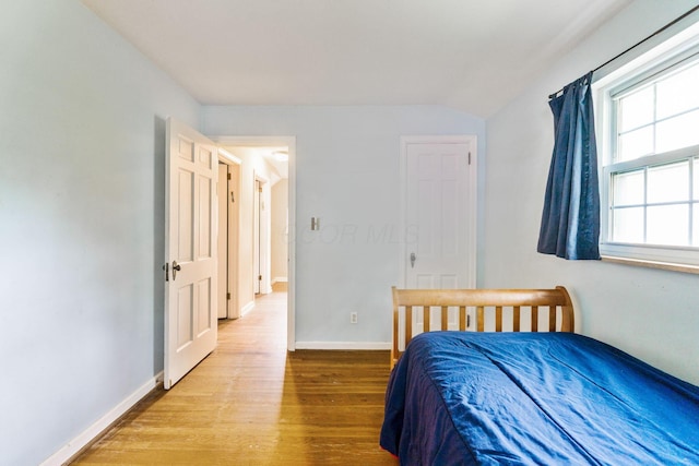 2909 Bryden Rd, Columbus, OH 43209 - bedroom featuring wood finished floors and vaulted ceiling