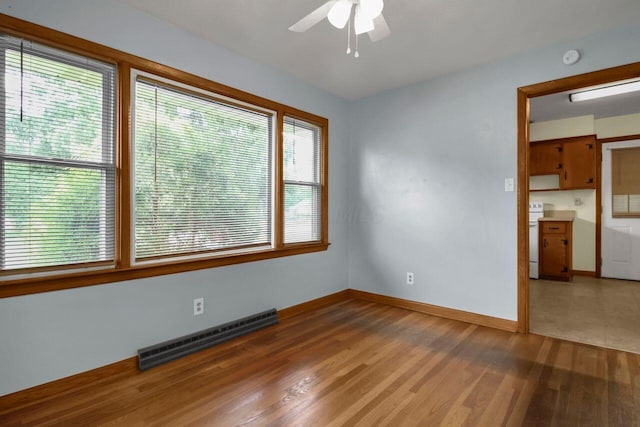 824 Colonial Dr, Heath, OH 43056 - empty room featuring baseboard heating, wood finished floors, and a ceiling fan