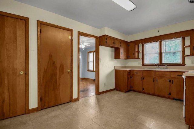 824 Colonial Dr, Heath, OH 43056 - kitchen with light countertops, brown cabinetry, and a ceiling fan