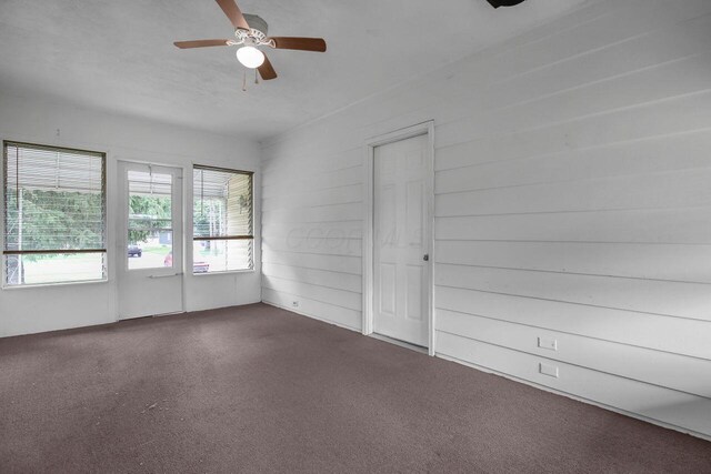 824 Colonial Dr, Heath, OH 43056 - unfurnished room with dark carpet and ceiling fan