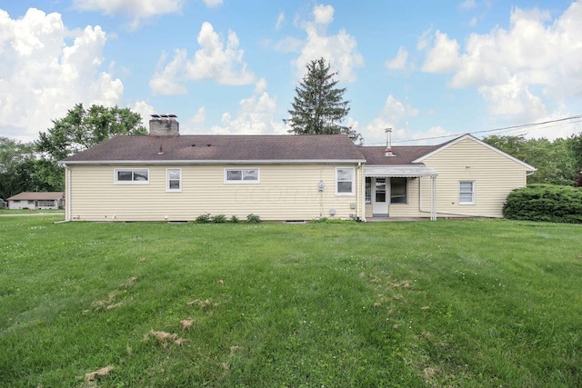824 Colonial Dr, Heath, OH 43056 - rear view of property with a yard and a chimney