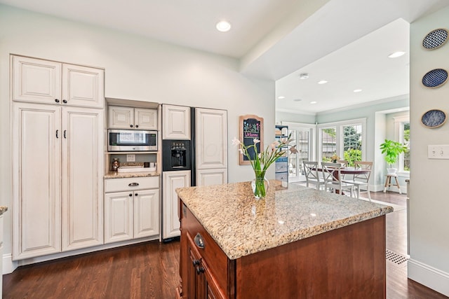 1968 Coventry Rd, Upper Arlington, OH 43212 - kitchen featuring stainless steel microwave, light stone counters, dark wood-type flooring, a center island, and recessed lighting