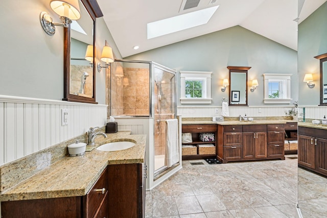 1968 Coventry Rd, Upper Arlington, OH 43212 - bathroom with a skylight, lofted ceiling, wainscoting, a shower stall, and two vanities
