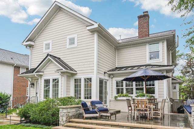 1968 Coventry Rd, Upper Arlington, OH 43212 - back of property featuring a chimney, a patio, and a standing seam roof