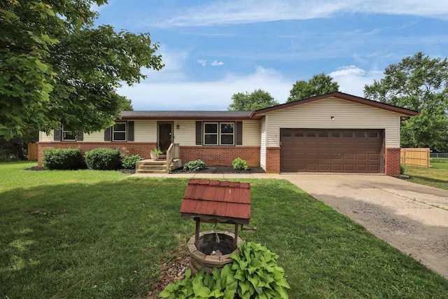 251 Florence Dr, Pickerington, OH 43147 - ranch-style home with brick siding, a fire pit, an attached garage, and concrete driveway