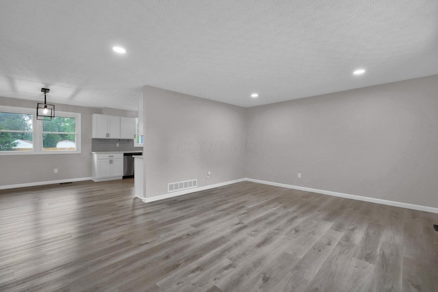 251 Florence Dr, Pickerington, OH 43147 - unfurnished living room with light wood-type flooring, recessed lighting, and a textured ceiling