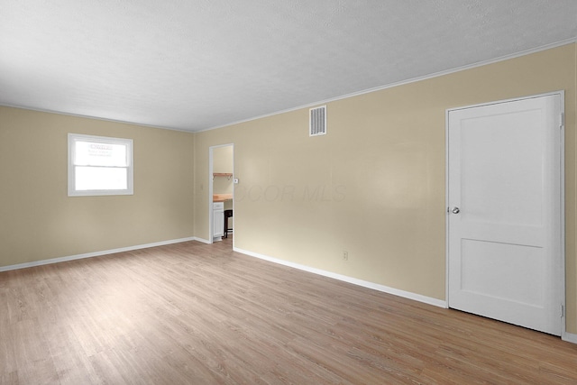1086 S Hampton Rd, Columbus, OH 43227 - empty room featuring light wood-style flooring, ornamental molding, and a textured ceiling